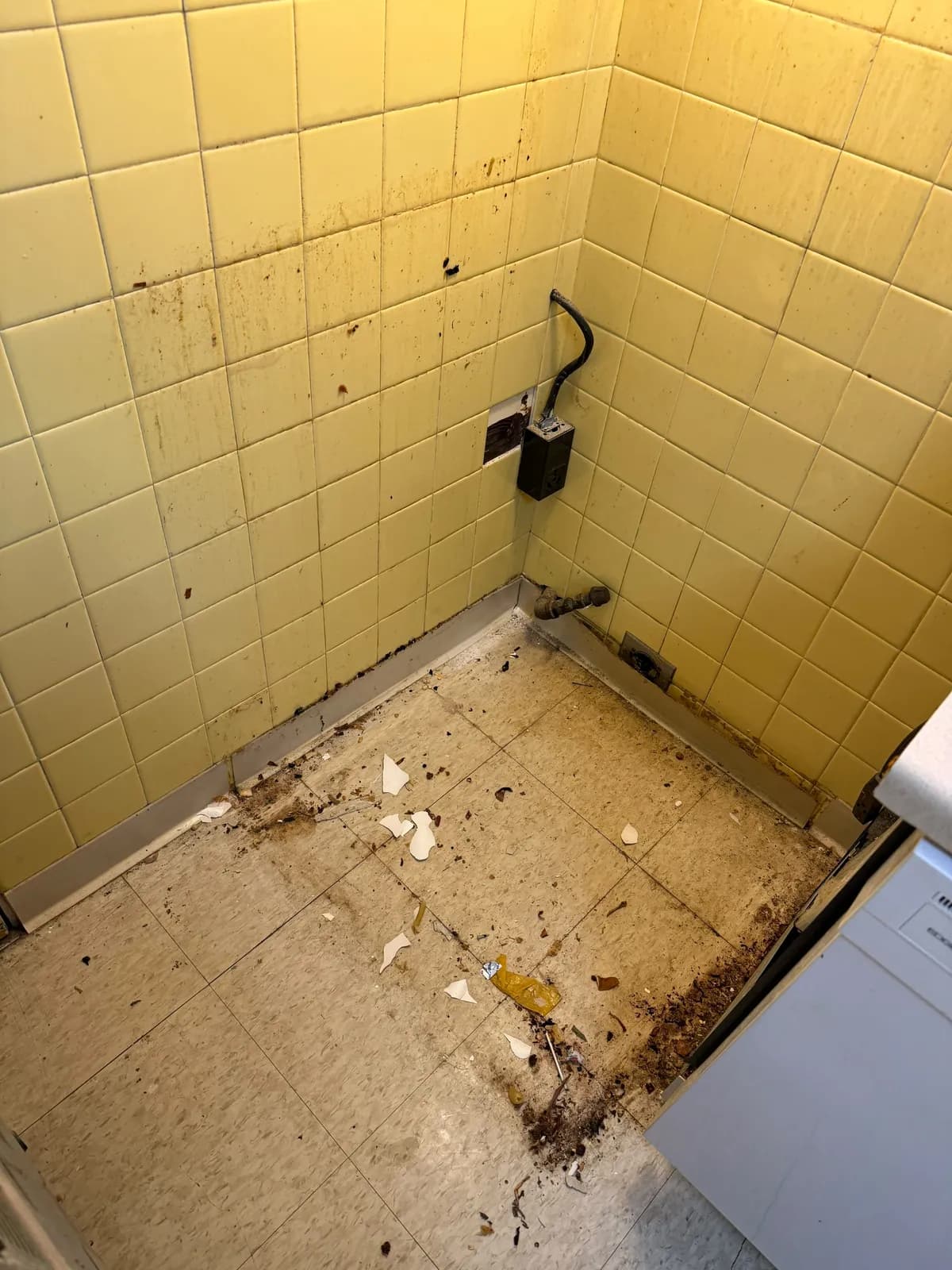 Before: Before and after of a yellow-tiled kitchen corner during a move-out clean by Maid With Precision, from debris and grime on the floor and baseboards to a clean floor and wiped-down tile