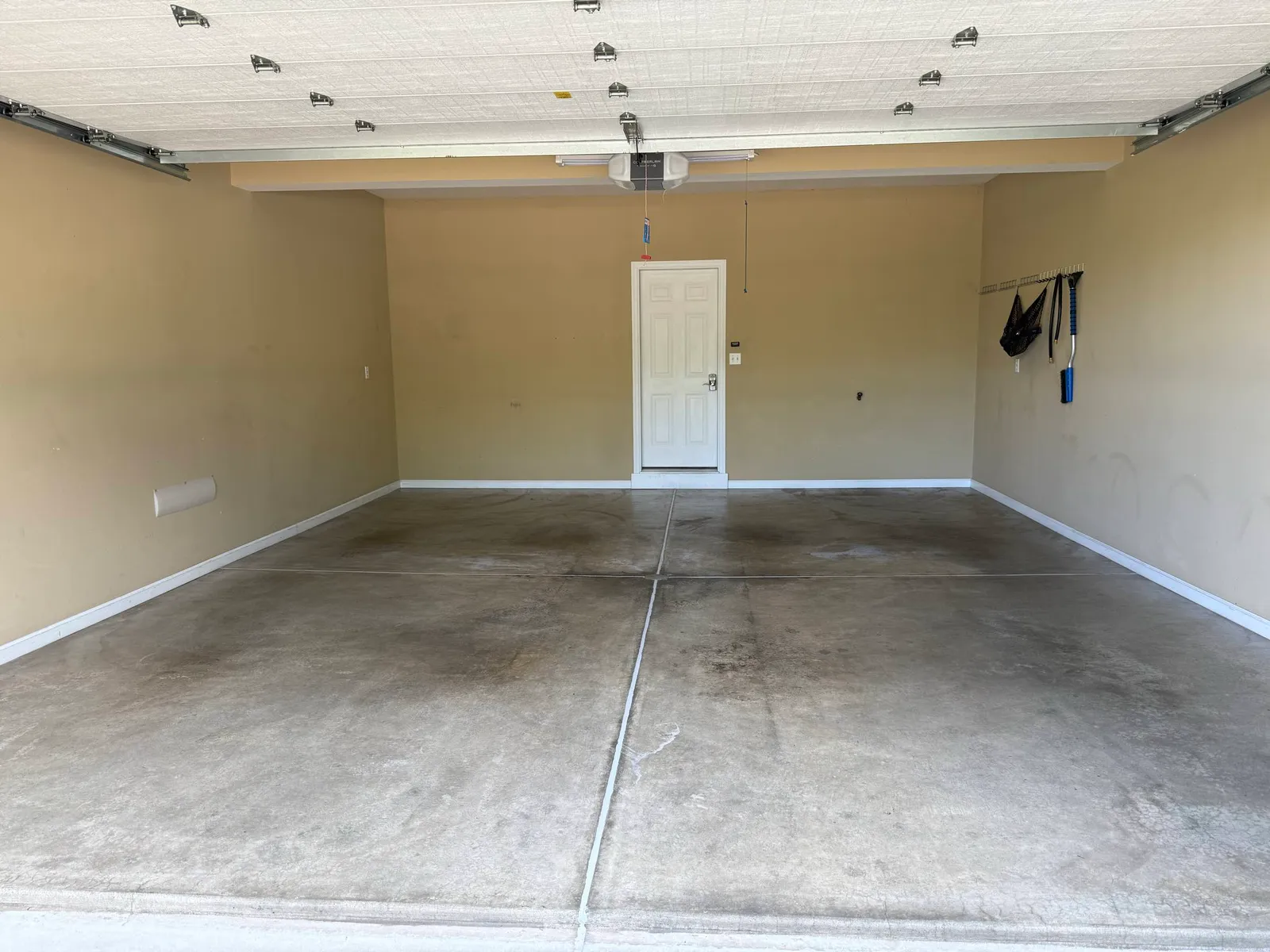 Emptied two-car garage with a freshly cleaned and sealed concrete floor by Maid With Precision