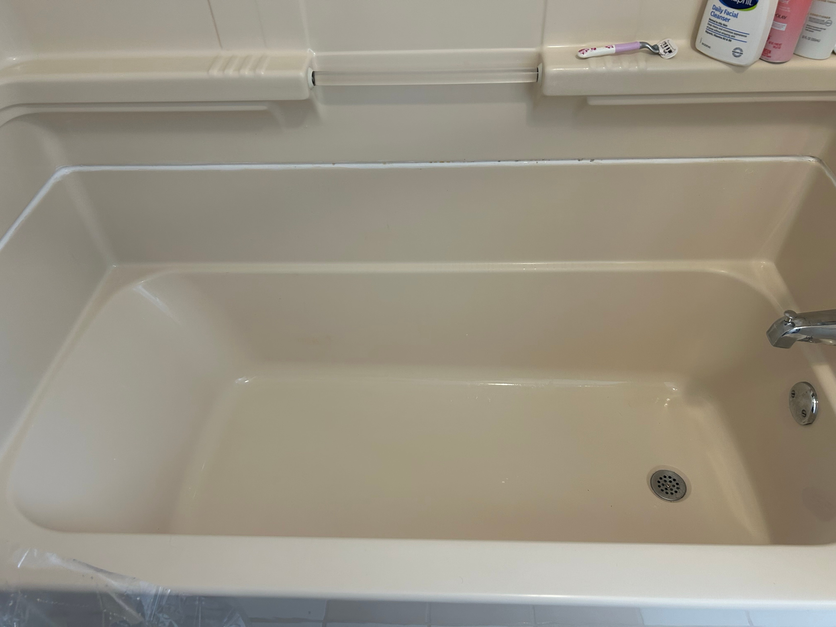 After: stained almond bathtub, from rust and mildew to a glossy finish
