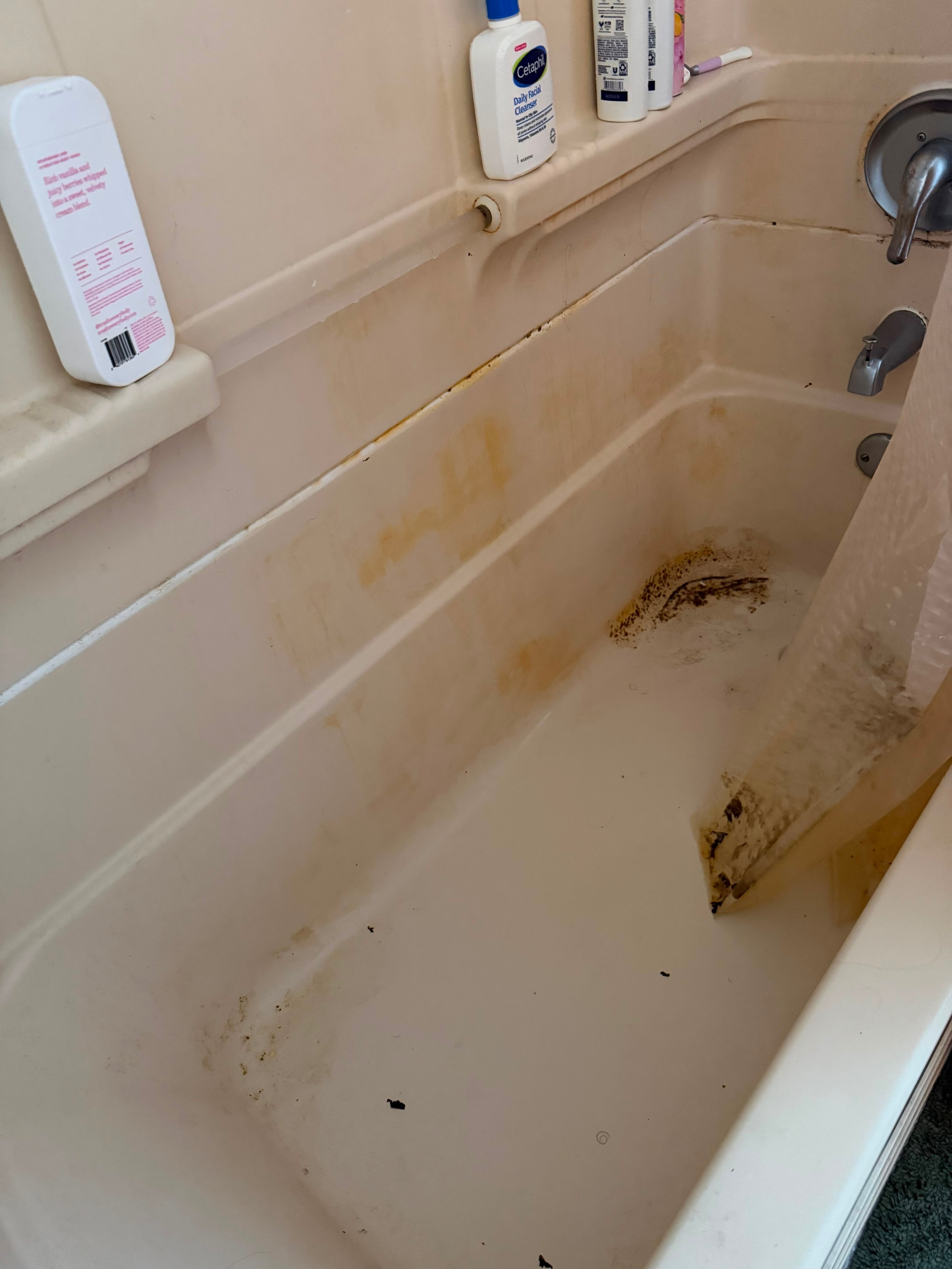 Before: stained almond bathtub, from rust and mildew to a glossy finish