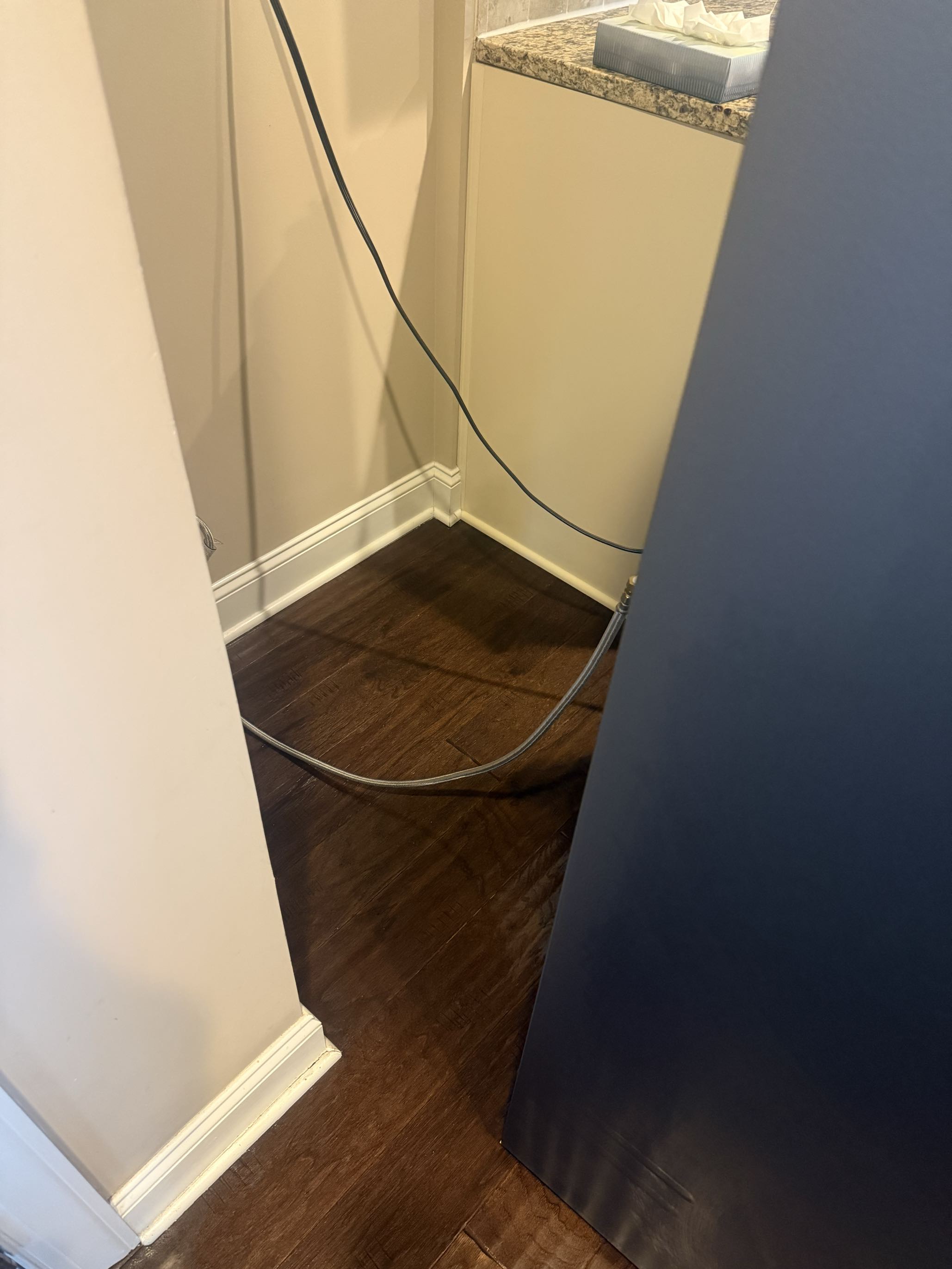 After: hardwood floor behind a refrigerator, from crumbs and debris to spotless
