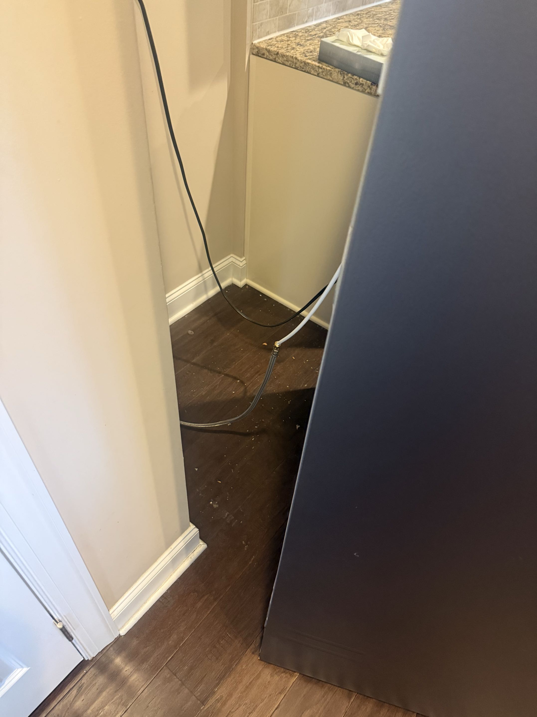Before: hardwood floor behind a refrigerator, from crumbs and debris to spotless